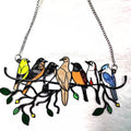 Colorful bird-shaped pendant on a chain against a white background