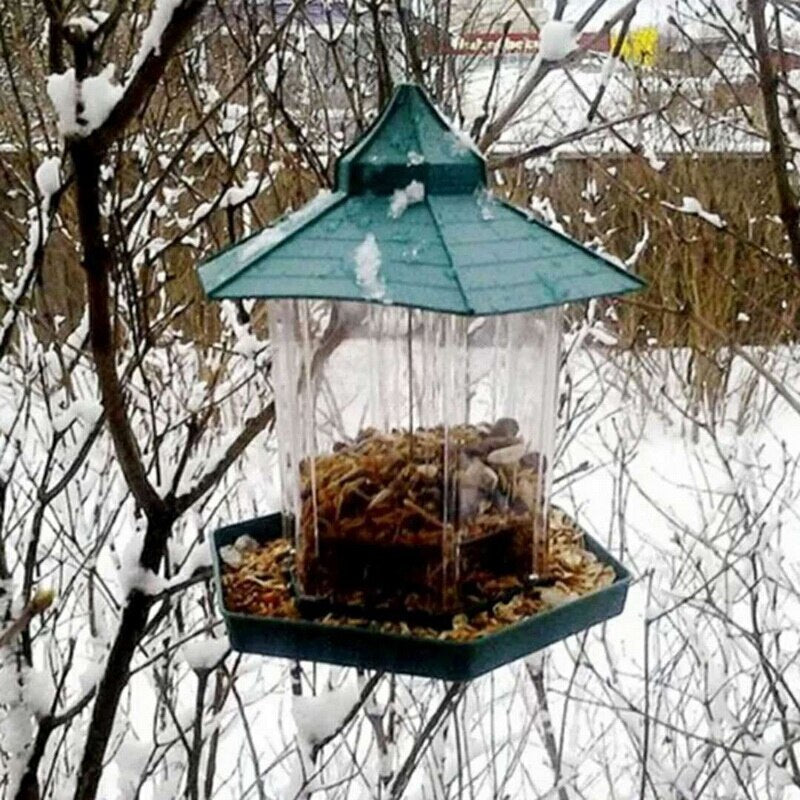 Bird feeder hanging from a tree in a snowy garden
