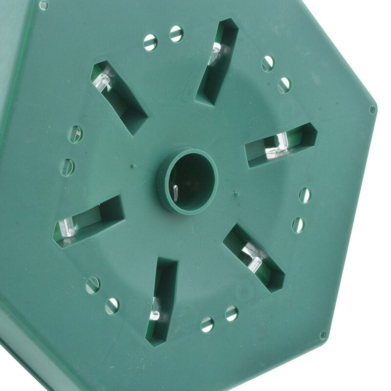 Green plastic component with multiple holes and slots on a white background