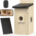 Wooden birdhouse with a camera and solar panel on a white background