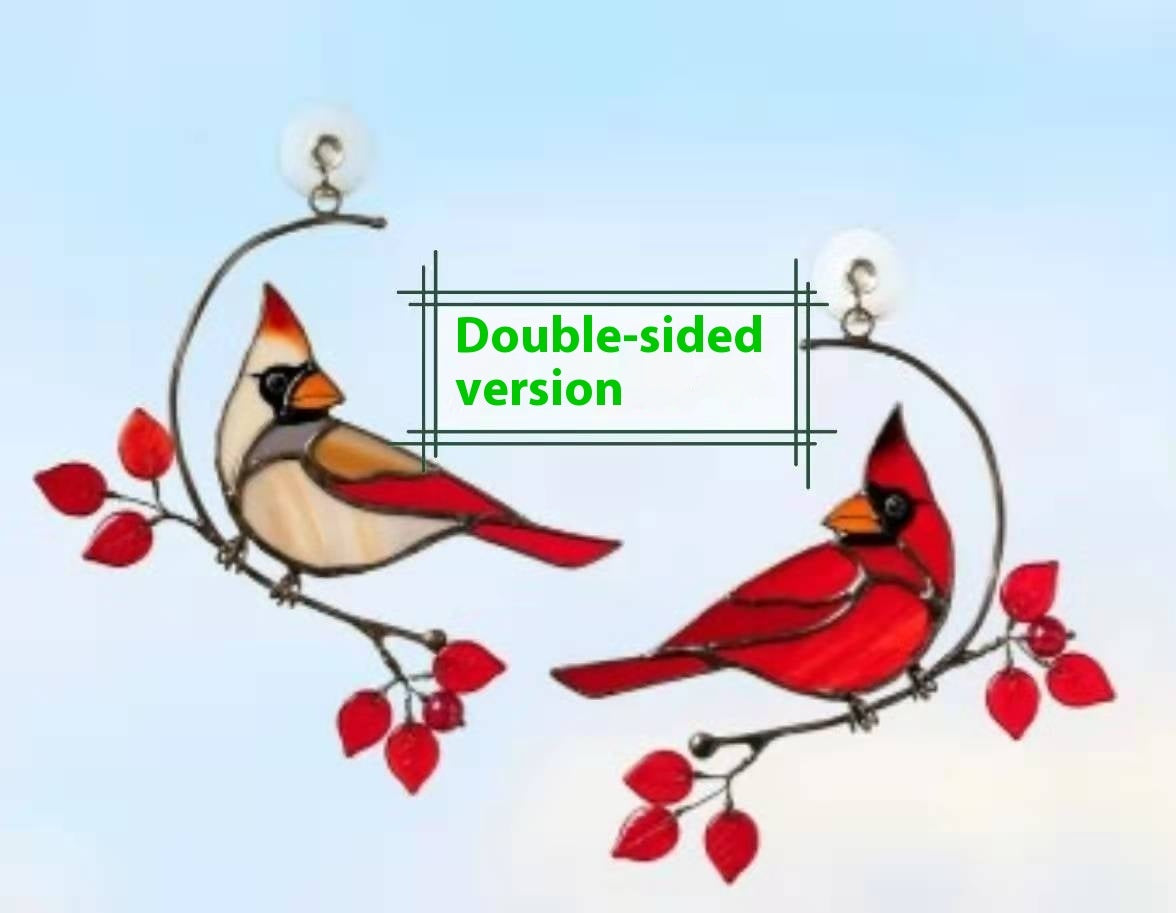 Double-sided bird ornament with cardinals on a branch against a light blue background.