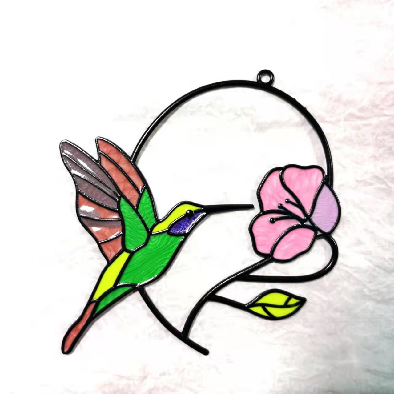 Stained glass hummingbird and flower suncatcher on a white background