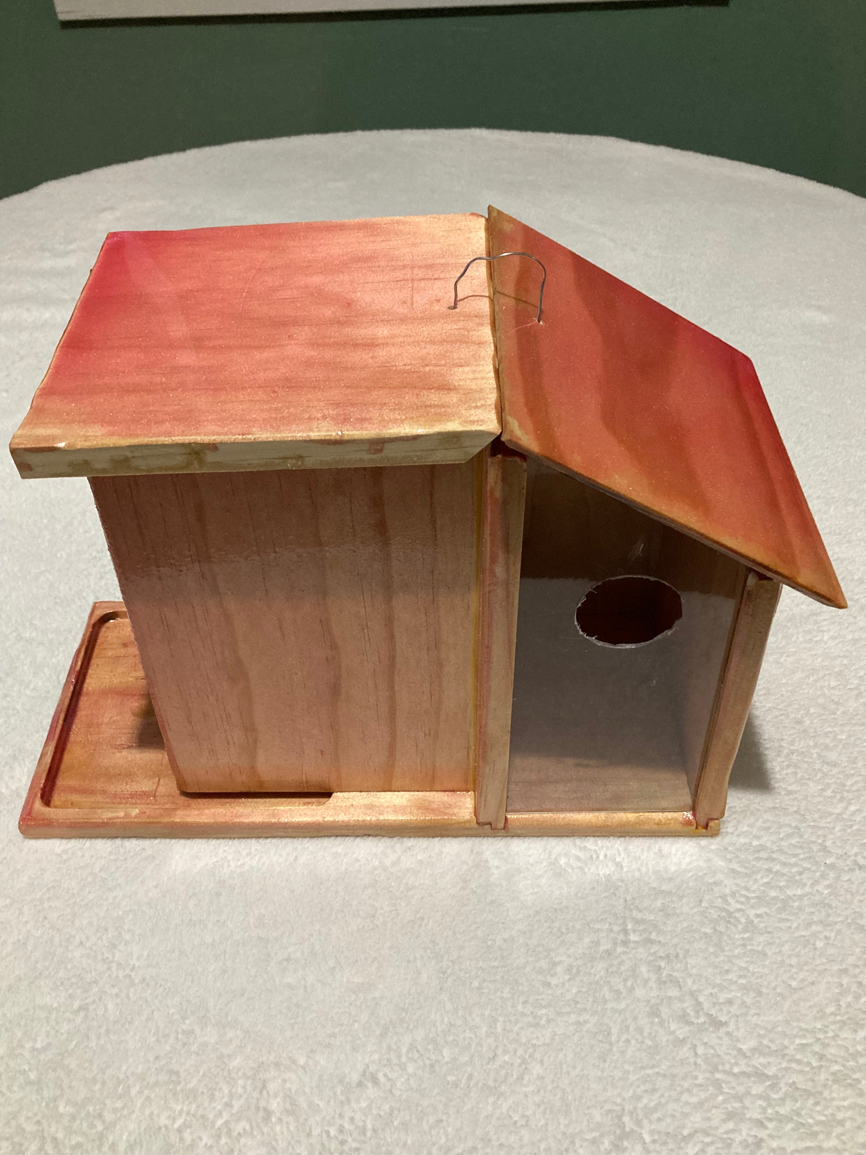Pastel colored handcrafted bird condo for backyard birds