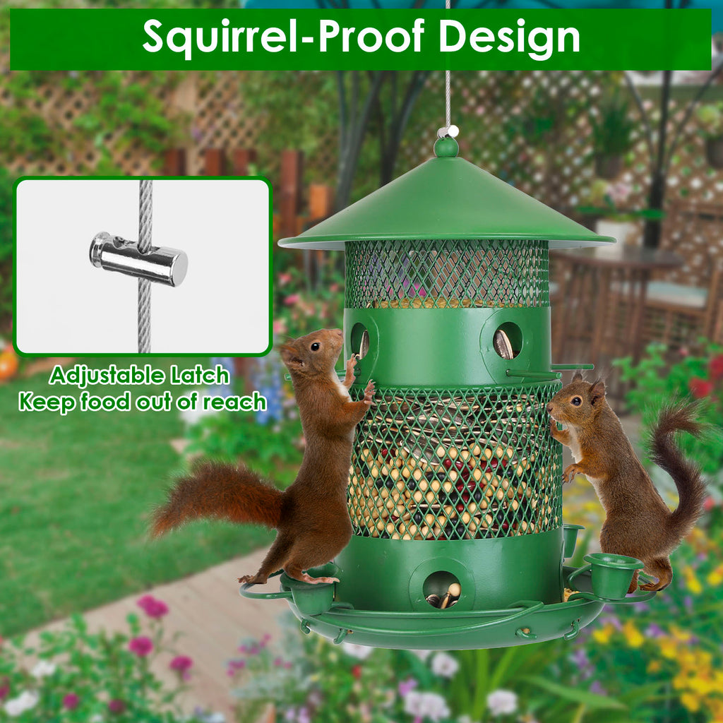 Green squirrel-proof bird feeder with two squirrels interacting, set against a garden background.